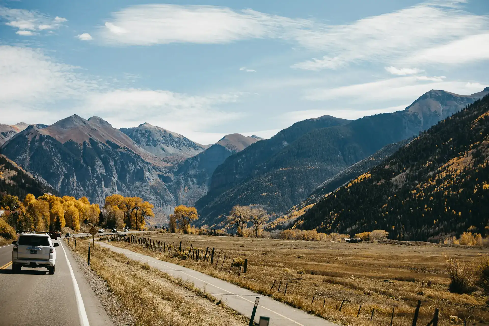 Mountain road through a green valley outside Telluride, Colorado