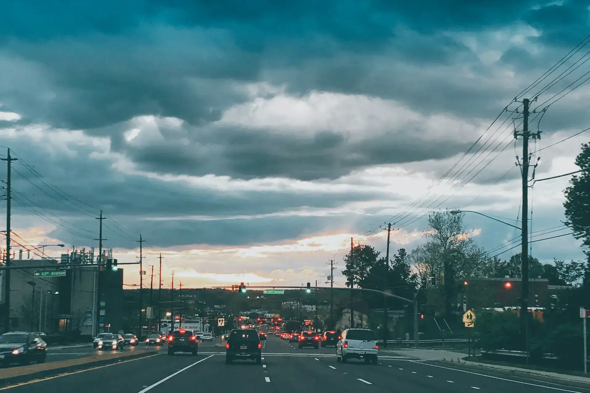 Cars driving on a Maryland road at sunset in Bowie