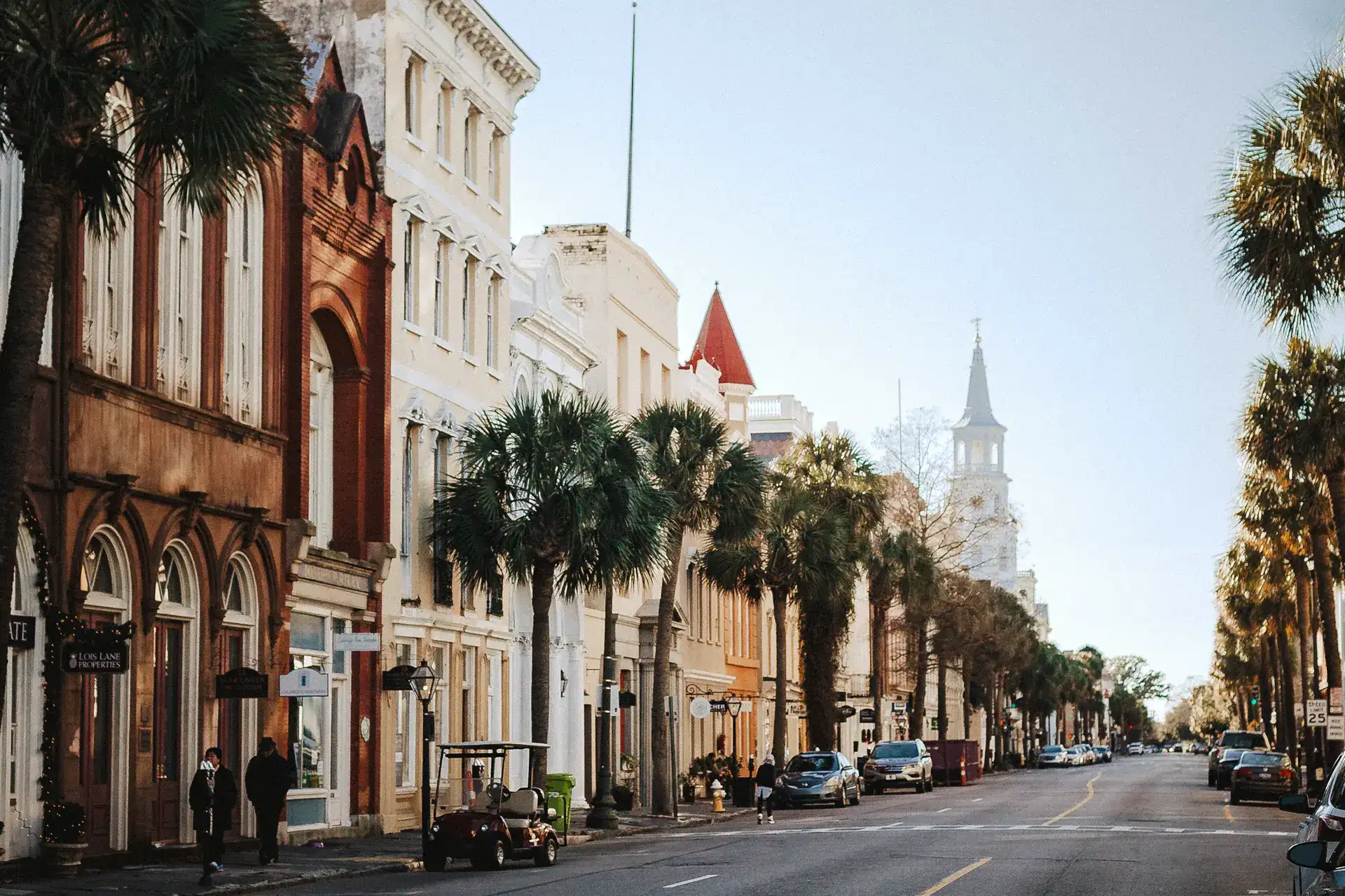 Street lined with tall buildings and palm trees in downtown Charleston, South Carolina